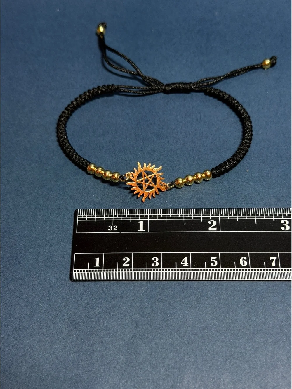 Antipossesion Charm Bracelet Gold toned with Black band
